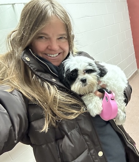 Sharon Rose holding Zippy the Shih-Poo puppy on her first day