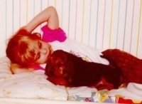 Bloodhound Puppy laying bed with a little girl