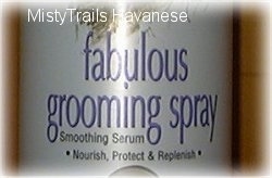 Close up - A bottle with the words - fabulous grooming spray Smoothing Serum Nourish, Protect and Replenish.
