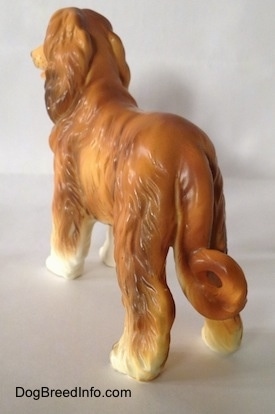 The back left side of a brown with white Vintage porcelain Lefton Japan Afghan Hound dog figurine.