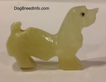 The right side of a stone Basset Hound figurine.