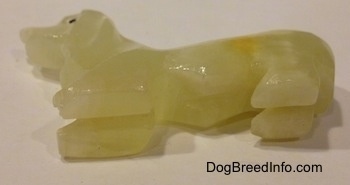 The underside of a stone Basset Hound figurine.