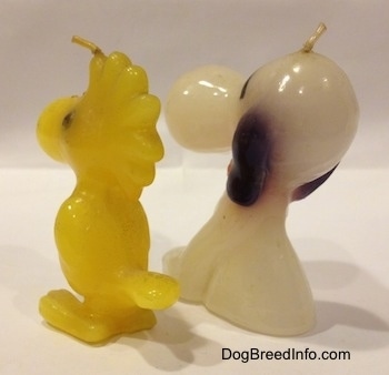 The back left side of a Snoopy and Woodstock 1970s candle set.