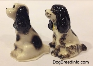 The left side of two different ceramic Cocker Spaniel figurines.