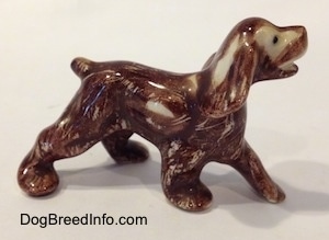 The right side of a Cocker Spaniel figurine painted with Aurasperse paint. The figurine has small black circles for eyes.