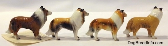 The right side of four Collie dog figurine variations. All of the figurines have white paws.