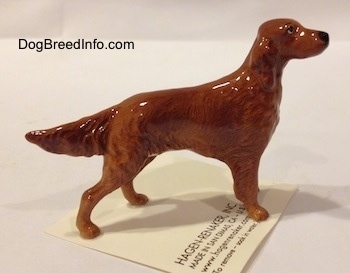 The right side of an Irish Setter figurine. The figurine has ears that are hard to tell from its body.