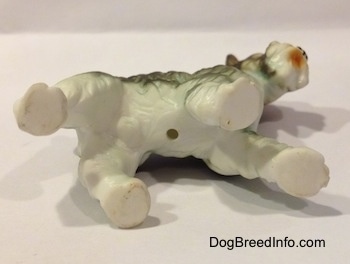 The underside of a bone china Miniature Schnauzer figurine. The figurine has a hole on its underside.