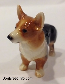 A black and tan Pembroke Welsh Corgi figurine. The figurine has fine face details.