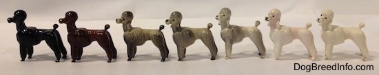 The left side of a Poodle standing figurine. There are seven different color vations. Each figurine has long legs.