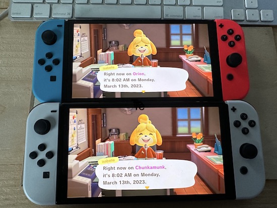 Two Nintendo switch game systems, one blue and red and the other white with Isabelle speaking