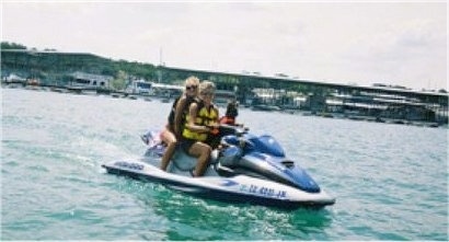 Isabelle the Silky Terrier is sharing a Jet Ski with two Women