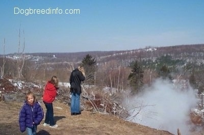 Two people looking at the steam and another walking away from the steam