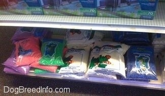 Bags of gravel that are different colored on a store shelf