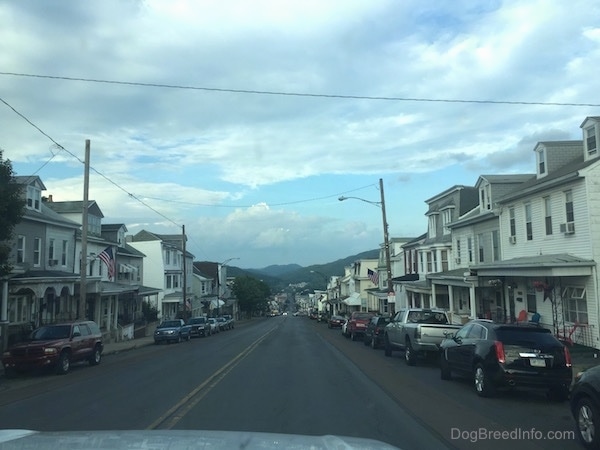 A look down the center of the street in Ashland, a neighboring town to Centralia with row homes and cars parked along both sides of the street