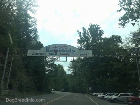 A Knoebels sign over a road that reads 'Welcome to Knoebels America's finest family fun park'.