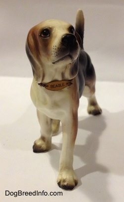 A black, brown and white ceramic Beagle figurine with a chain ID collar that reads "Beagle". The figurine has a very detailed face.
