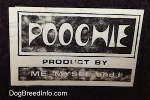 Close up - The underside of a highly detailed figurine of the head of a Bloodhound dog. Image showing the sticker that reads, "POOCHIE PRODUCT BY ME MYSEL and I"