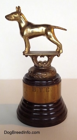 A golden Bull Terrier statue at the top of a Bull Terrier Club trophy.