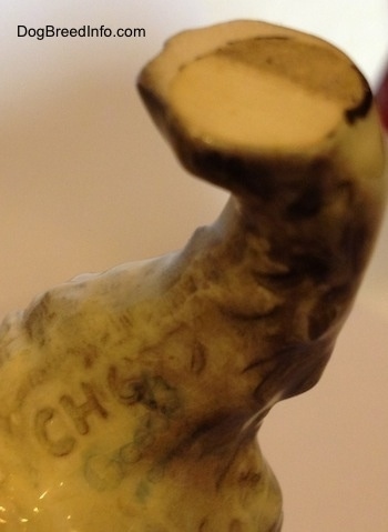 Close up - The underside of a Cairn Terrier figurine that has the engraved letter/number combination - CH693 - on it.