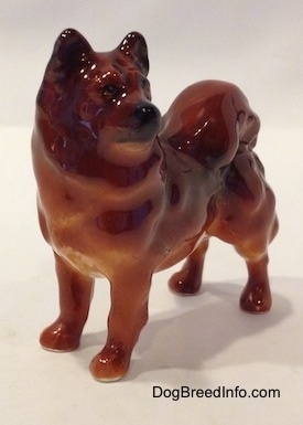 A Chow Chow figurine that is in a standing pose. The figurine has fine eye details.