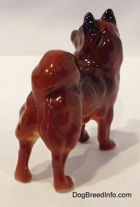 The back right side of a Chow Chow figurine that is in a standing pose. The figurine has its tail on its back.