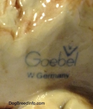 Close up - The underside of a porcelain Chow Chow figurine that has the stamp of a Goebel W.Germany logo.