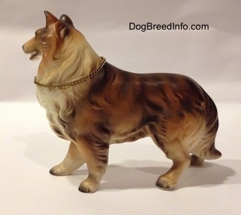 The left side of a brown, black and white ceramic Rough Collie figurine. The figurine has great hair details.