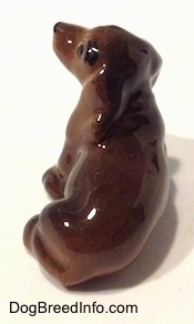 Topdown view of the backside of a Dachshund figurine. It is hard to differentiate the features of the figurine from its body.