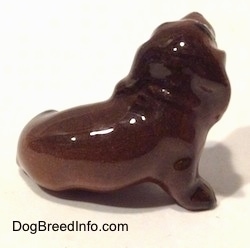 The right side of a Dachshund figurine. The figurine is very glossy.