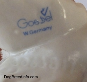 Close up - The underside of a figurine. On the underside is the stamped logo of a Goebel W.Germany.