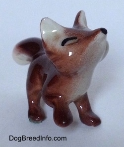 The front right side of a Baby Fox figurine. The chest of the figurine is white.