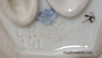 Close up - The underside of a French Bulldog figurine. On the bottom there is a Goebel W.Germany stamp and engraved under that are - Ch 191 - and the words - Dep.