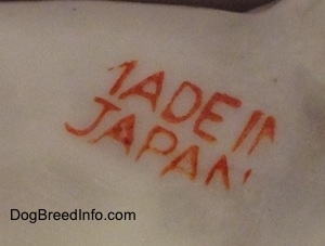 Close up - The underside of a bone china Jack Russell Terrier dog figurine, that is showing the "Made in Japan" stamp. 