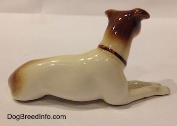 The right side of a brown and white Jack Russell Terrier figurine. The figurine has short ears.