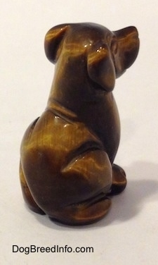 The back right side of a carved stone Labrador Retriever figurine.