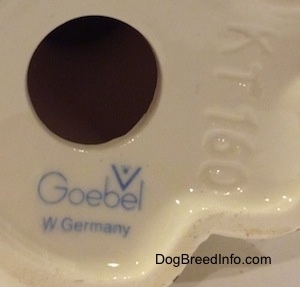 Close up - The underside of a figurine. There is a hole in the figurine and under the hole is the stamped logo of Goebel W.Germant