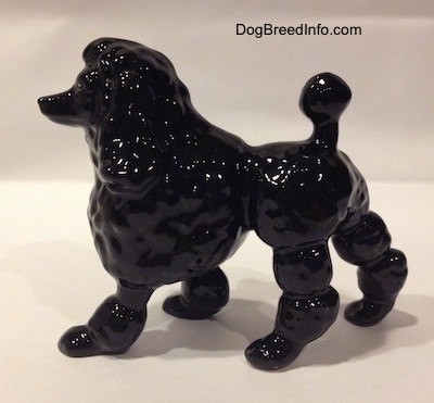 The left side of a black porcelain Poodle figurine.