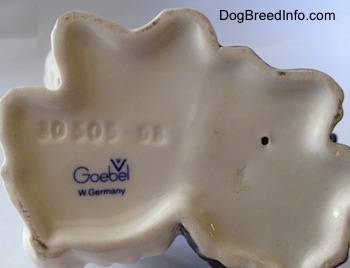 The underside of two sitting Skye Terriers that are one figurine. It has the stamp of Goebel W.Germany on the bottom and above that is an engraving that reads '30505-08'.
